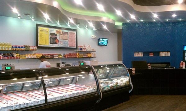 Inside Fresh Fish House, with seafood display counters and a colorful dining area